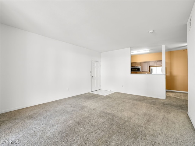 231 W Horizon Ridge Parkway Unit 212, Henderson, NV 89012 - unfurnished living room featuring carpet flooring and baseboards