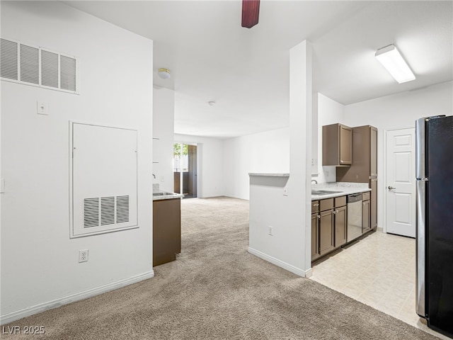 231 W Horizon Ridge Parkway Unit 212, Henderson, NV 89012 - kitchen featuring appliances with stainless steel finishes, light colored carpet, a ceiling fan, light countertops, and baseboards