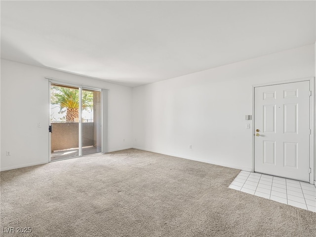 231 W Horizon Ridge Parkway Unit 212, Henderson, NV 89012 - empty room featuring light carpet, baseboards, and light tile patterned flooring