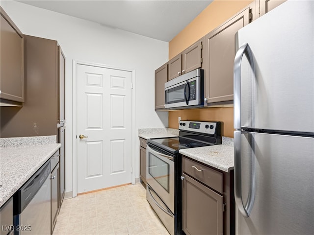 231 W Horizon Ridge Parkway Unit 212, Henderson, NV 89012 - kitchen with stainless steel appliances and light stone counters