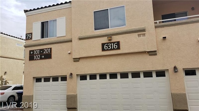 6316 Beige Bluff St Unit 201, North Las Vegas, NV 89081 - view of building exterior featuring a garage