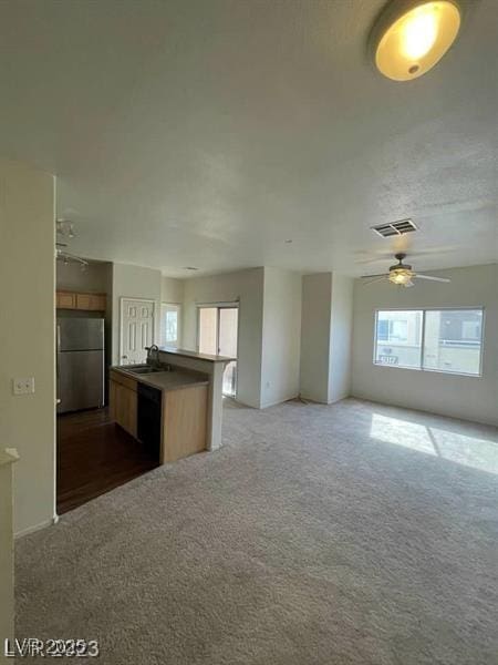 6316 Beige Bluff St Unit 201, North Las Vegas, NV 89081 - kitchen featuring freestanding refrigerator, open floor plan, a sink, dark carpet, and a ceiling fan