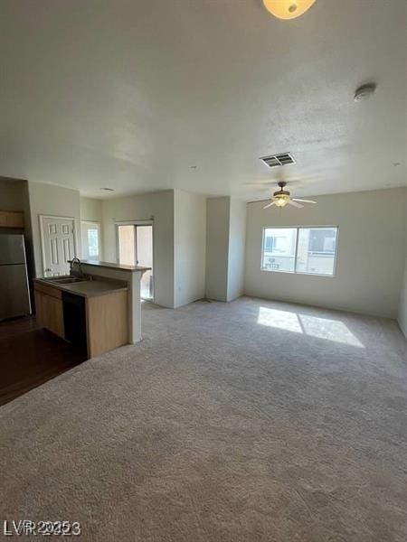 6316 Beige Bluff St Unit 201, North Las Vegas, NV 89081 - unfurnished living room featuring a sink, dark carpet, and a ceiling fan