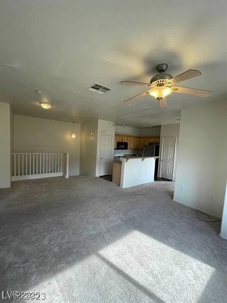 6316 Beige Bluff St Unit 201, North Las Vegas, NV 89081 - unfurnished living room featuring a ceiling fan and light colored carpet