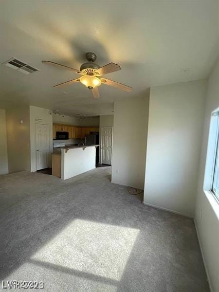 6316 Beige Bluff St Unit 201, North Las Vegas, NV 89081 - unfurnished living room featuring ceiling fan and light colored carpet