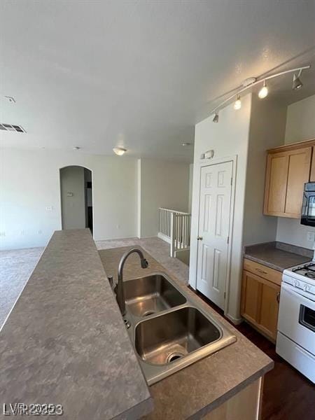 6316 Beige Bluff St Unit 201, North Las Vegas, NV 89081 - kitchen with white gas stove, a sink, open floor plan, and arched walkways