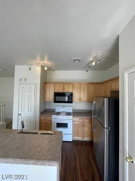 6316 Beige Bluff St Unit 201, North Las Vegas, NV 89081 - kitchen featuring black microwave, freestanding refrigerator, white gas range oven, a sink, and dark wood-type flooring