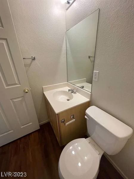 6316 Beige Bluff St Unit 201, North Las Vegas, NV 89081 - bathroom featuring vanity, wood finished floors, toilet, and a textured wall