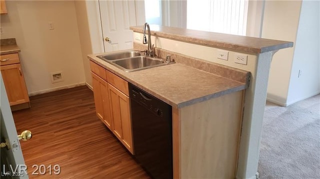 6316 Beige Bluff St Unit 201, North Las Vegas, NV 89081 - kitchen with black dishwasher, a sink, baseboards, and a center island with sink