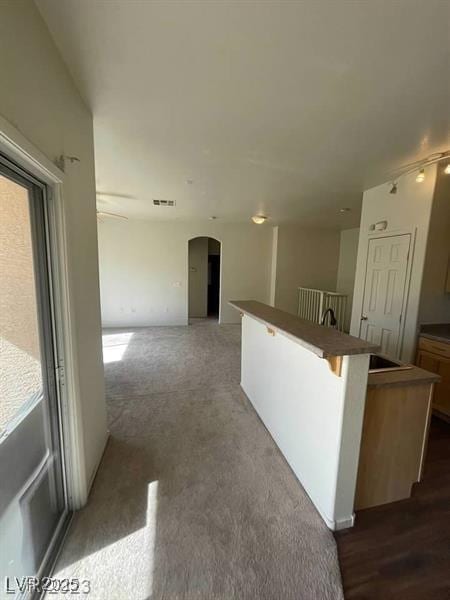 6316 Beige Bluff St Unit 201, North Las Vegas, NV 89081 - hall featuring arched walkways and an upstairs landing