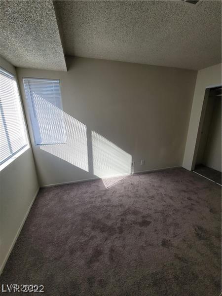 4363 Spencer St Unit 8, Las Vegas, NV 89119 - unfurnished room featuring carpet floors, a textured ceiling, and baseboards