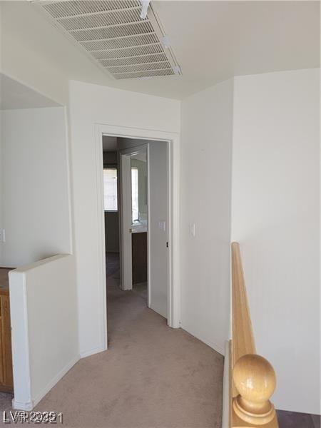 7290 Sheared Cliff Ln Unit 102, Las Vegas, NV 89149 - hallway with an upstairs landing and light carpet