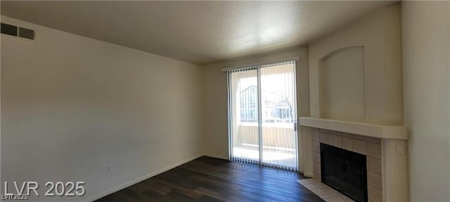 75 N Valle Verde Dr Unit 2121, Henderson, NV 89074 - unfurnished living room with wood finished floors, a fireplace, and baseboards