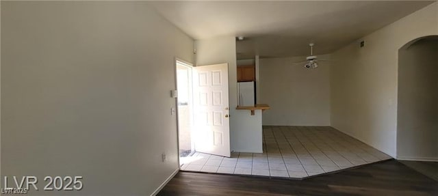 75 N Valle Verde Dr Unit 2121, Henderson, NV 89074 - empty room with arched walkways, light wood-type flooring, a ceiling fan, and baseboards