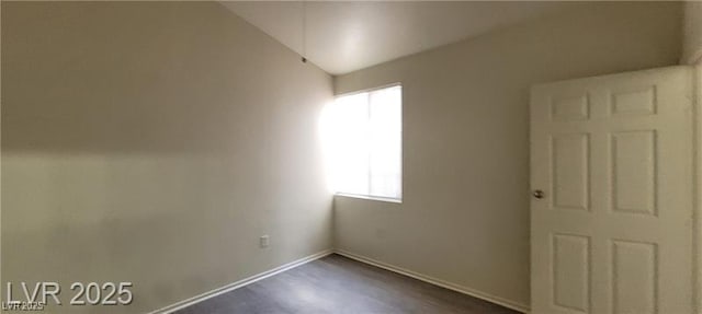 75 N Valle Verde Dr Unit 2121, Henderson, NV 89074 - spare room with baseboards, vaulted ceiling, and dark wood-type flooring