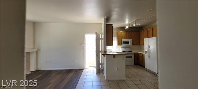75 N Valle Verde Dr Unit 2121, Henderson, NV 89074 - kitchen featuring white appliances, light tile patterned floors, light countertops, and a breakfast bar area