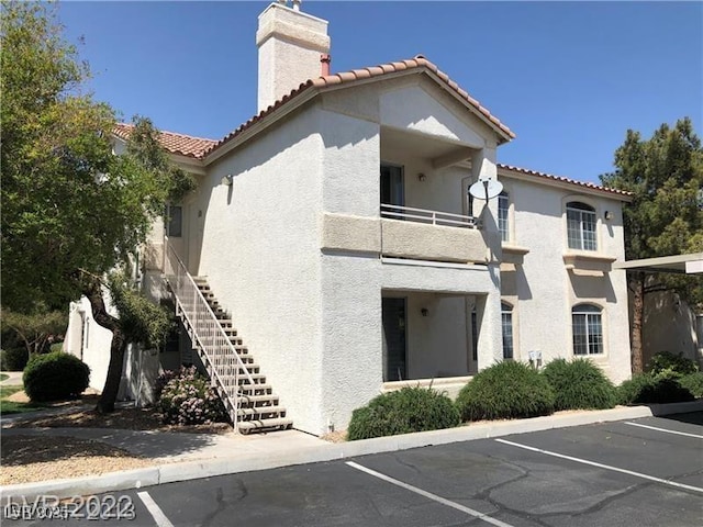 75 N Valle Verde Dr Unit 2121, Henderson, NV 89074 - view of building exterior with uncovered parking and stairs