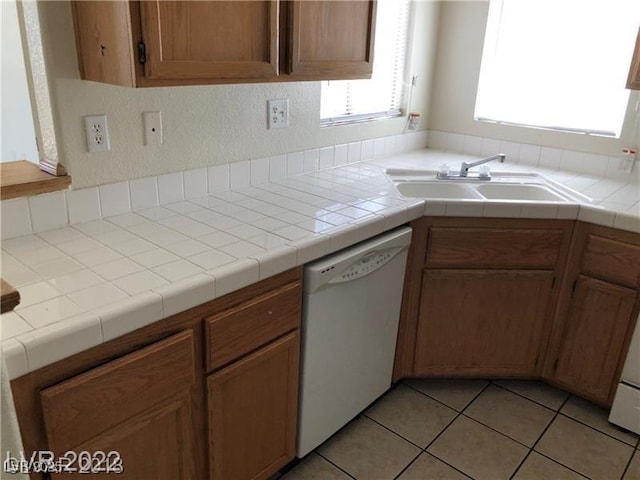 75 N Valle Verde Dr Unit 2121, Henderson, NV 89074 - kitchen featuring white dishwasher, a sink, light tile patterned floors, brown cabinets, and light countertops