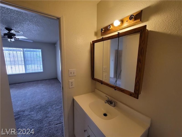 4795 Via, San Andros, Las Vegas, NV 89103 - bathroom with vanity, a ceiling fan, and a textured ceiling