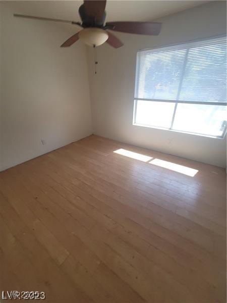 2761 Lodestone Dr Unit 63, Las Vegas, NV 89117 - empty room with hardwood / wood-style floors and a ceiling fan