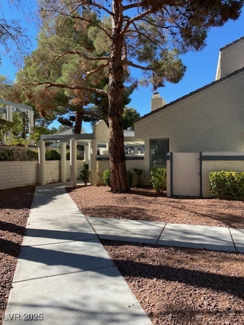 2761 Lodestone Dr Unit 63, Las Vegas, NV 89117 - view of front facade featuring stucco siding and a chimney