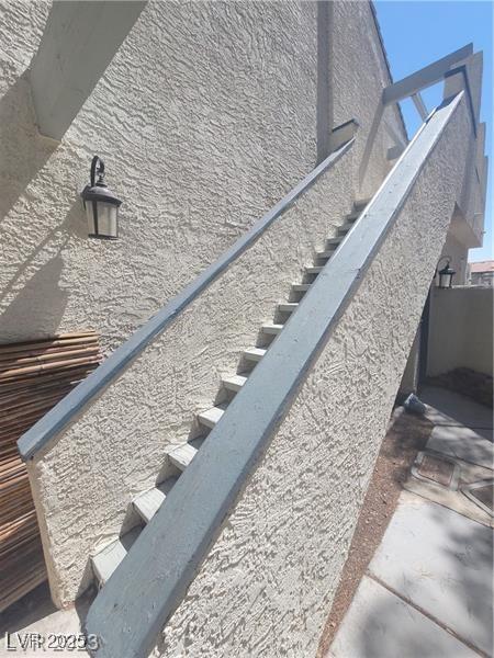 2761 Lodestone Dr Unit 63, Las Vegas, NV 89117 - exterior view of stairs and stucco siding