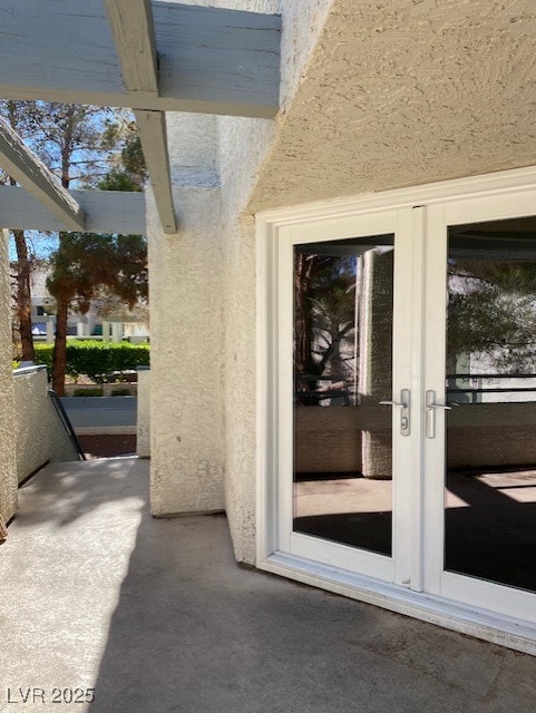 2761 Lodestone Dr Unit 63, Las Vegas, NV 89117 - view of exterior entry featuring french doors and stucco siding