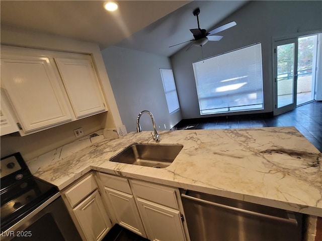 2761 Lodestone Dr Unit 63, Las Vegas, NV 89117 - kitchen featuring stainless steel appliances, a sink, lofted ceiling, white cabinetry, and light stone countertops