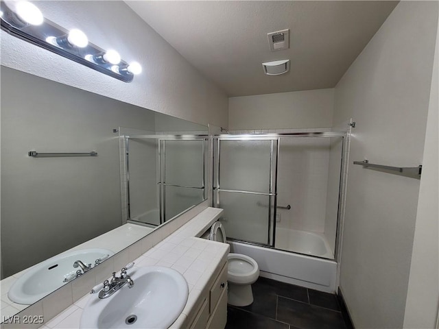 2761 Lodestone Dr Unit 63, Las Vegas, NV 89117 - bathroom featuring vanity, toilet, tile patterned flooring, and shower / bath combination with glass door