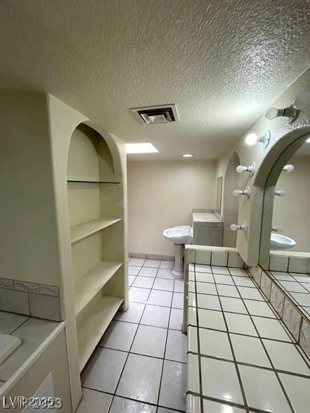 3797 Monument St, Las Vegas, NV 89121 - full bath featuring tile patterned flooring, a bathtub, and a textured ceiling