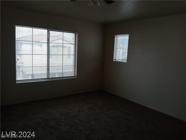 70 Belle Essence Ave, Las Vegas, NV 89123 - empty room featuring dark carpet, baseboards, and ceiling fan