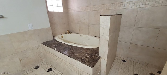 1301 Madison Ave, Las Vegas, NV 89106 - bathroom with a jetted tub, tile walls, and tile patterned floors