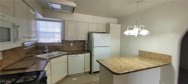 1301 Madison Ave, Las Vegas, NV 89106 - kitchen with white appliances, a sink, a peninsula, tasteful backsplash, and a chandelier