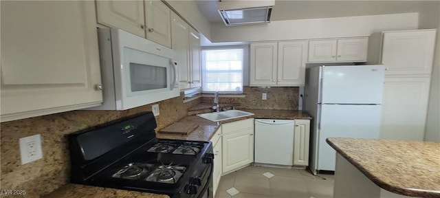 1301 Madison Ave, Las Vegas, NV 89106 - kitchen with white appliances, a sink, tasteful backsplash, light tile patterned floors, and white cabinetry