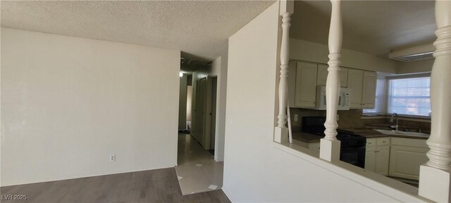 1301 Madison Ave, Las Vegas, NV 89106 - hallway featuring a sink, dark wood-type flooring, and a textured ceiling