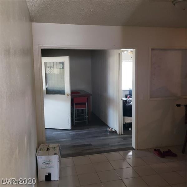 5284 Wellesley Ave, Las Vegas, NV 89122 - hall with tile patterned flooring and a textured ceiling
