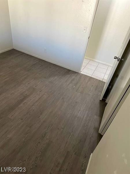 5284 Wellesley Ave, Las Vegas, NV 89122 - spare room featuring dark wood-style flooring and baseboards