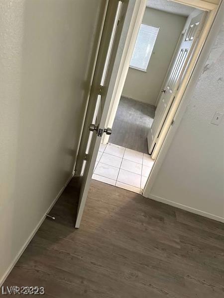 5284 Wellesley Ave, Las Vegas, NV 89122 - corridor with dark wood-style flooring and baseboards
