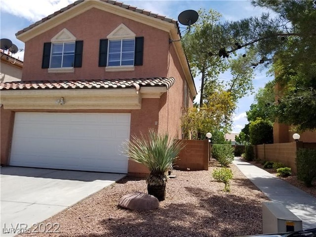 9937 La Paca Ave, Las Vegas, NV 89117 - view of front of property featuring a tiled roof, driveway, an attached garage, and stucco siding