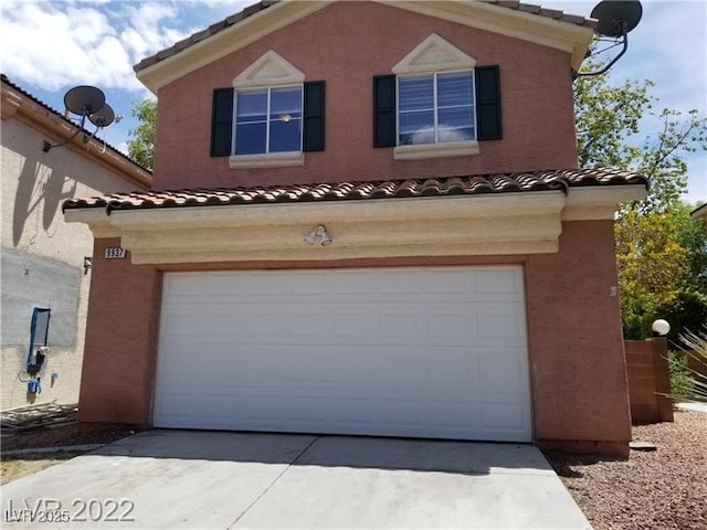 9937 La Paca Ave, Las Vegas, NV 89117 - view of front of home featuring a garage, a tile roof, driveway, and stucco siding