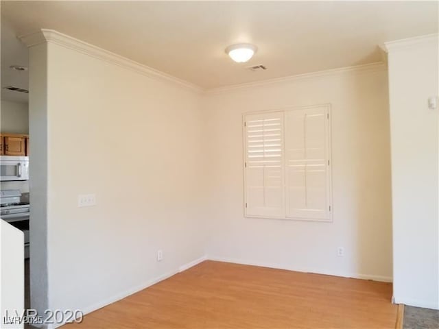 9937 La Paca Ave, Las Vegas, NV 89117 - empty room with crown molding, light wood-style flooring, and baseboards
