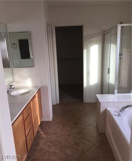 8749 Brilliant Star Dr, Las Vegas, NV 89178 - bathroom with vanity, a bath, a shower stall, and tile patterned floors