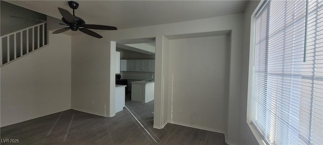 8695 Canfield Canyon Ave, Las Vegas, NV 89178 - corridor featuring plenty of natural light, dark wood-type flooring, a sink, and baseboards
