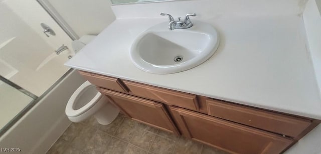 8695 Canfield Canyon Ave, Las Vegas, NV 89178 - bathroom featuring toilet, vanity, tile patterned flooring, and a shower