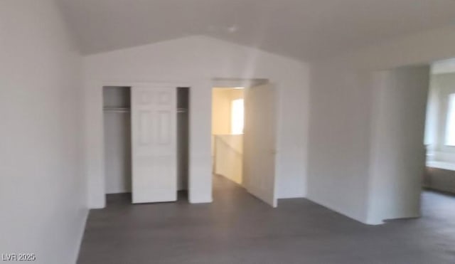 8695 Canfield Canyon Ave, Las Vegas, NV 89178 - unfurnished bedroom with vaulted ceiling and a closet