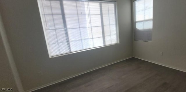 8695 Canfield Canyon Ave, Las Vegas, NV 89178 - empty room featuring dark wood-style flooring, baseboards, and healthy amount of natural light