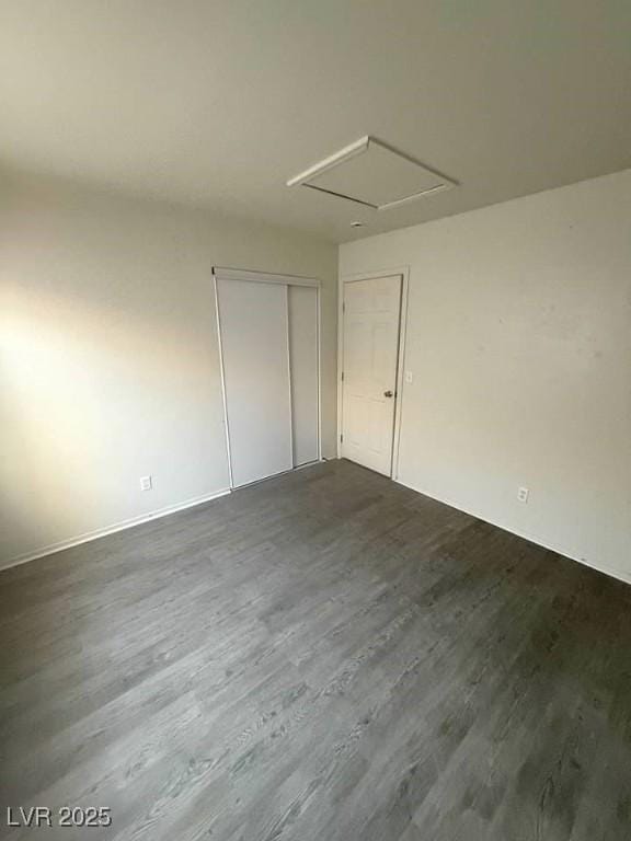 5115 Blossom Ave, Las Vegas, NV 89142 - unfurnished room featuring dark wood-style flooring and attic access