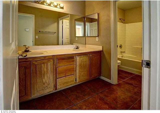 5115 Blossom Ave, Las Vegas, NV 89142 - full bath featuring tile patterned flooring, double vanity, toilet, and washtub / shower combination