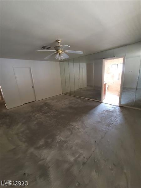 3480 E Hacienda Ave, Las Vegas, NV 89120 - unfurnished bedroom featuring unfinished concrete floors and ceiling fan