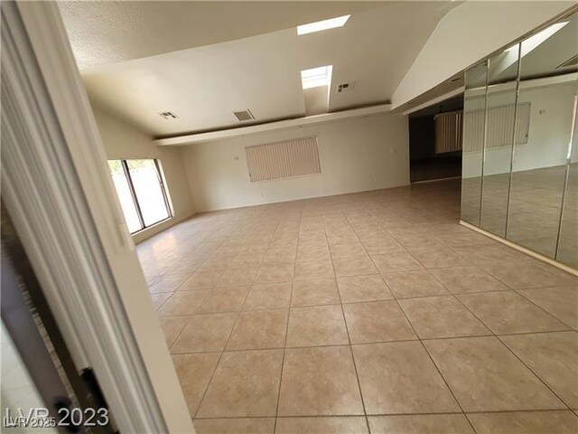 3480 E Hacienda Ave, Las Vegas, NV 89120 - empty room featuring light tile patterned floors and lofted ceiling